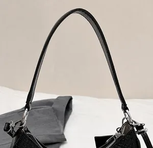 Detail showing crocodile texture black leather strap and glossy silver metal hardware