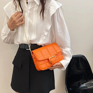Chic orange quilted crossbody bag with golden chain strap and buckle for women