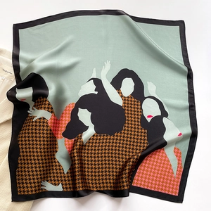 Mint green silk scarf with houndstooth illustration flat lay on a light blazer