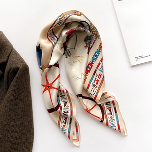 Detail of silk scarf with Egyptian patterns, pharaoh icons and hieroglyphics on beige