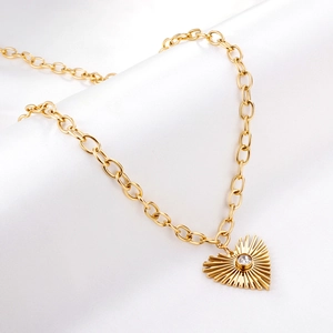 Gold stainless steel heart pendant necklace with sunburst texture and center zircon stone