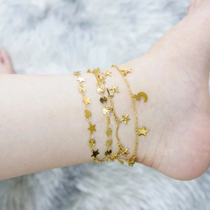 Three-layer gold anklet set with star and moon charms on minimalist steel chains