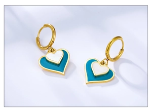 Detail of gold double heart earrings with sky blue and pearl white enamel charms