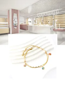 Close-up of double-layer gold stainless steel anklet with colorful enamel flowers