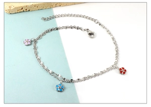 Close-up of double-layer stainless steel anklet with colorful enamel flower pendants