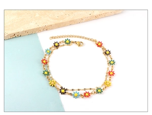 Detail of double-layer gold daisy anklet featuring colorful enamel floral charms