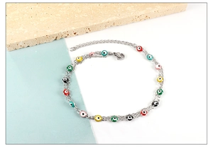Detail of bohemian evil eye beaded chain with colorful enamel charms and adjustable clasp