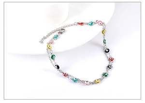 Close-up of double-layer stainless steel anklet with colorful evil eye beads and lobster clasp