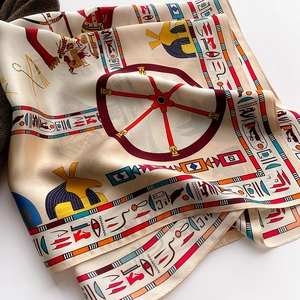 Detailed close-up of Egyptian theme silk scarf with hieroglyphs and vibrant prints