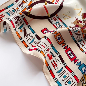 Detailed macro view of Egyptian mural silk scarf with fine rolled edge stitching