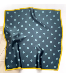 Close-up of leopard pattern silk scarf with blue polka dots and yellow borders