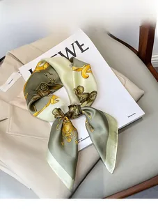 Detail of silk-like square scarf with baroque floral print on beige suit background