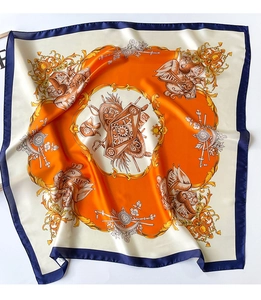 Detailed macro view of baroque circular patterns and silk texture on a navy square scarf