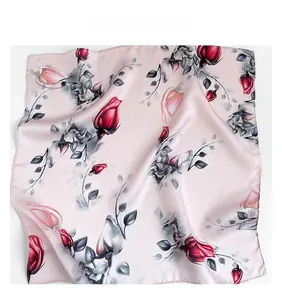 Detailed view of floral silk scarf showing elegant pink rose pattern and satin luster