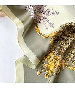 Detail of silk-texture scarf with gold baroque floral patterns and satin luster folds