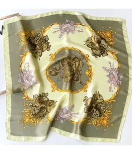 Detailed pattern of silk scarf featuring baroque medals and equestrian motifs in olive green