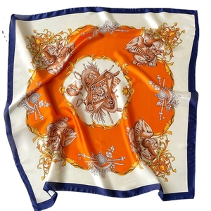 Elegant baroque print silk scarf with gold patterns and orange border in a flat layout