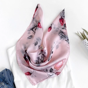 Elegant silk scarf with pink rose print styled on white t-shirt and blue denim jeans