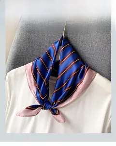 Classic striped silk neckerchief in royal blue and pink tied over a white t-shirt