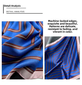 Macro detail of silk scarf featuring blue geometric patterns and pink stitched edges