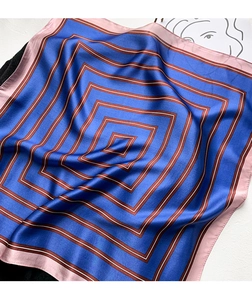 Detail of silk scarf with navy blue geometric stripes and soft pink borders