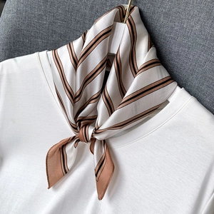 Classic brown and black striped mulberry silk scarf elegantly tied on a white t-shirt