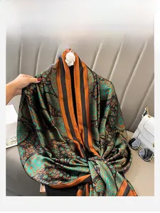 Close-up of paisley and striped silk scarf with elegant caramel and green patterns