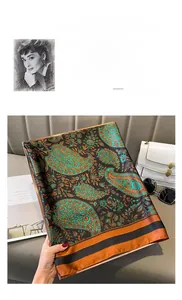 Detailed macro shot of paisley pattern silk scarf with premium hemmed edge and satin texture