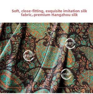 Close-up of faux silk paisley shawl fabric showing smooth texture and drape in blue and orange
