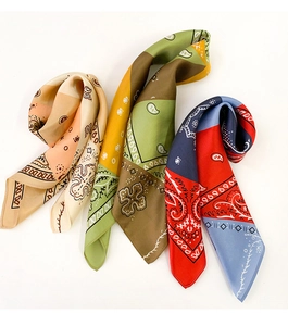Detail showing various silk square scarves with colorful bohemian paisley patterns