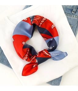 Close-up of red and blue paisley silk scarf paired with casual white t-shirt and jeans