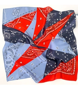 Close-up of bohemian silk scarf with red and blue paisley geometric patchwork pattern
