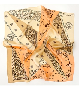 Detail of soft paisley satin silk scarf featuring elegant orange and beige floral patterns