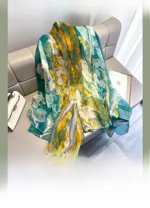 Detail of floral chiffon scarf with yellow and green flower prints on soft fabric