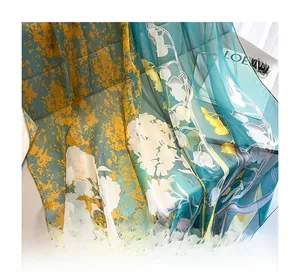 Detail of artistic floral scarf with yellow and dark teal lily of the valley print