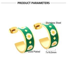 Detail of C-shaped gold plated stainless steel earrings with green daisy pattern enamel