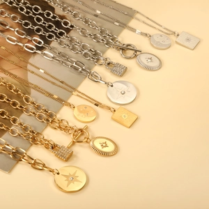 Collection of stainless steel star and moon pendant necklaces in gold and silver finishes