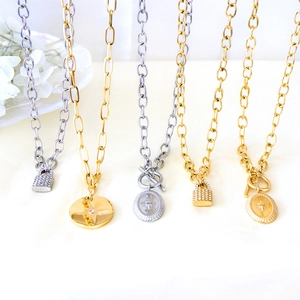 Modern oval pendant necklace set with celestial lucky star motifs in gold and silver