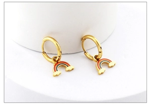 Close-up of gold hoop earrings with colorful rainbow pendants and cloud details
