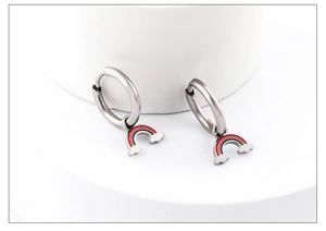 Rainbow hoop earrings with colorful enamel clouds hanging on a white cylinder stand