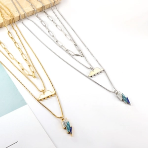 Layered gold and silver necklaces featuring gradient crystal cloud and lightning pendants