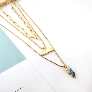 Three-layer gold necklace with cloud and lightning charms featuring blue rhinestones