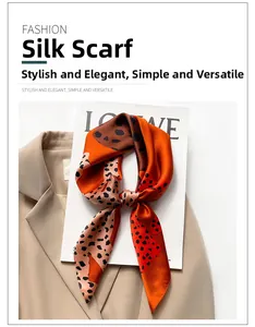 Detail of silk leopard print scarf tied in a knot on a chic fashion book and blazer