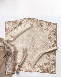 Detailed texture of beige silk square scarf featuring delicate floral prints and patterns