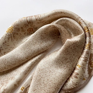 Detailed view of the elegant floral silk scarf with premium hand-rolled edges and texture