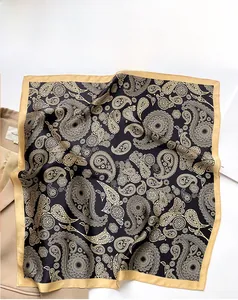 Detail of silk square scarf with gold paisley pattern over a beige blazer