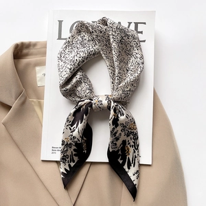 Floral silk square scarf with vintage pattern styled on a blazer and magazine