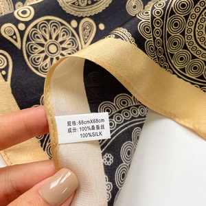 Detail of 68cm mulberry silk scarf showing paisley pattern and fabric texture