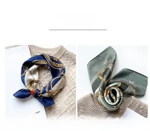 Detail view of navy and grass green silk scarves with chain patterns on knitwear