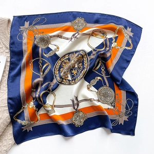 Silk square scarf with equestrian chain print and crown emblem on knit sweater background